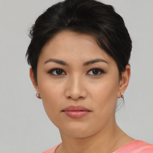 Joyful asian young-adult female with short  brown hair and brown eyes