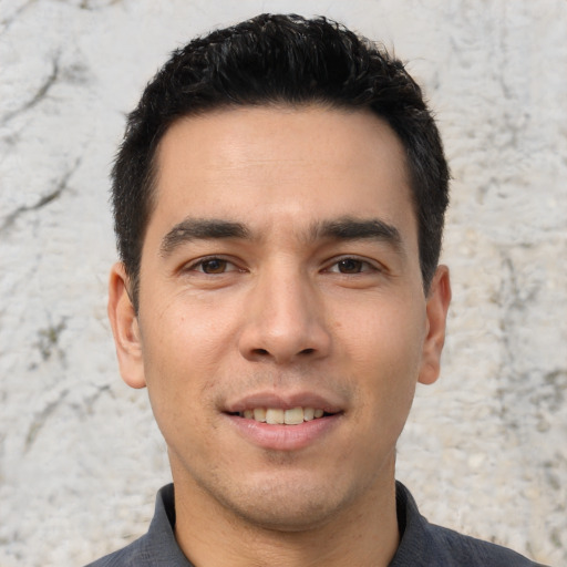 Joyful asian young-adult male with short  brown hair and brown eyes
