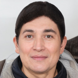 Joyful white adult male with short  black hair and brown eyes