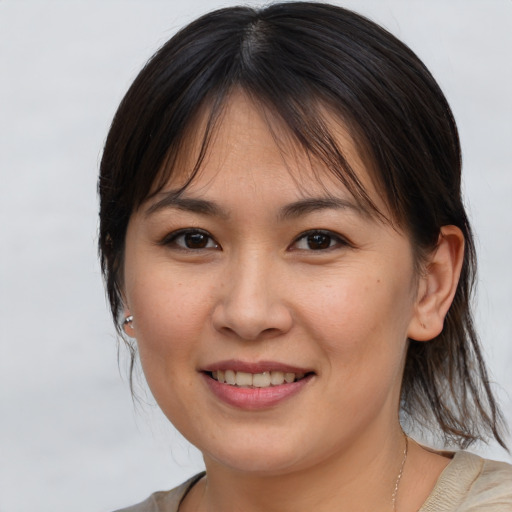 Joyful white young-adult female with medium  brown hair and brown eyes