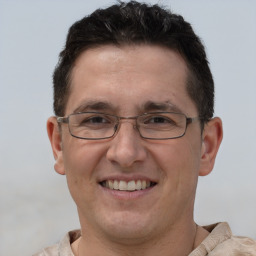 Joyful white adult male with short  brown hair and brown eyes