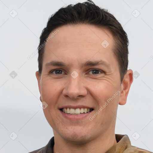 Joyful white adult male with short  brown hair and brown eyes