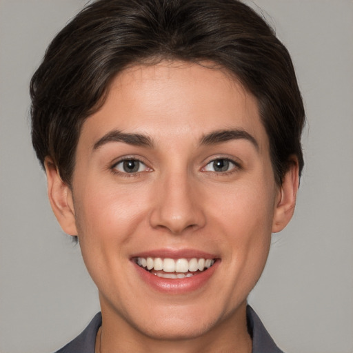 Joyful white young-adult female with short  brown hair and brown eyes