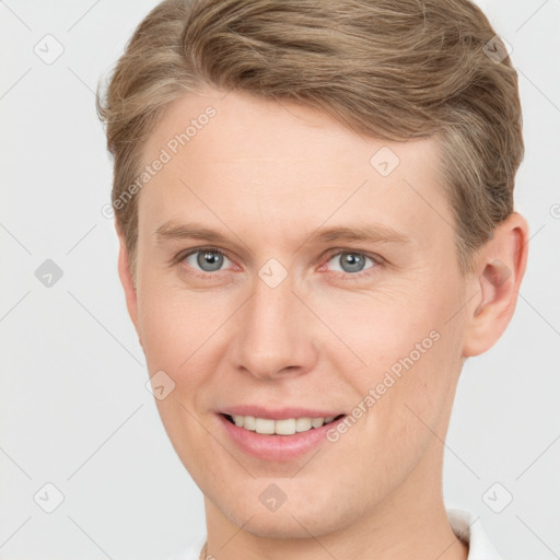 Joyful white young-adult male with short  brown hair and grey eyes