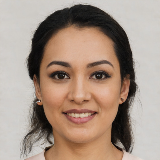 Joyful latino young-adult female with medium  black hair and brown eyes