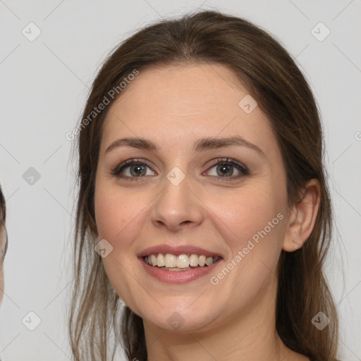 Joyful white young-adult female with long  brown hair and grey eyes