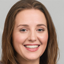 Joyful white young-adult female with long  brown hair and green eyes