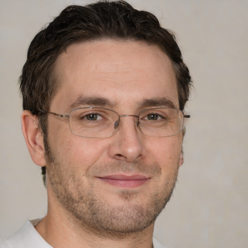 Joyful white adult male with short  brown hair and brown eyes