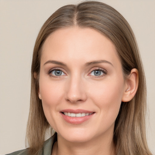 Joyful white young-adult female with long  brown hair and blue eyes