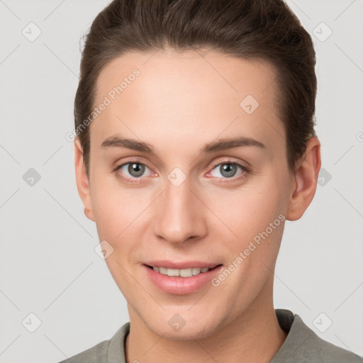 Joyful white young-adult female with short  brown hair and grey eyes