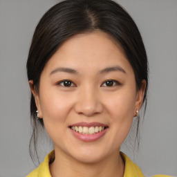 Joyful white young-adult female with medium  brown hair and brown eyes