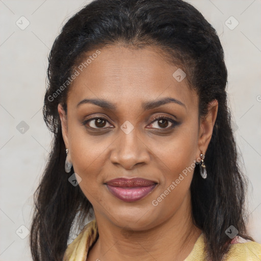 Joyful black young-adult female with long  brown hair and brown eyes