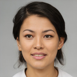 Joyful asian young-adult female with medium  brown hair and brown eyes