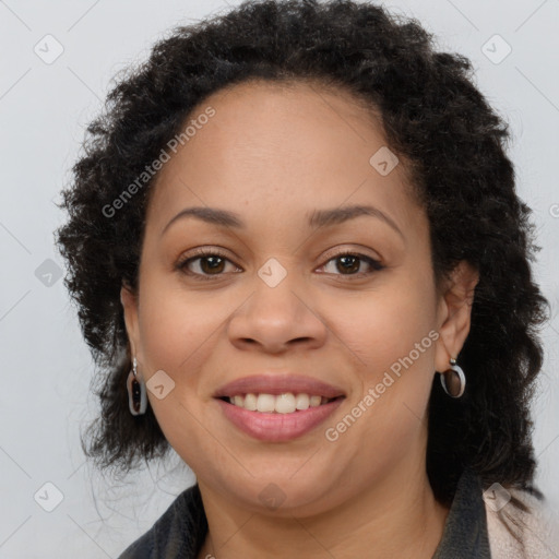 Joyful black young-adult female with long  brown hair and brown eyes