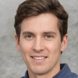 Joyful white adult male with short  brown hair and grey eyes