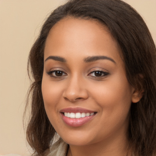 Joyful white young-adult female with long  brown hair and brown eyes