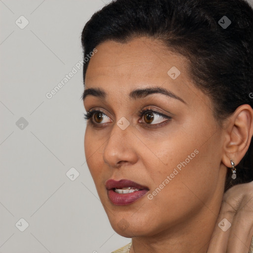 Joyful latino young-adult female with short  black hair and brown eyes