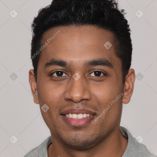 Joyful black young-adult male with short  black hair and brown eyes