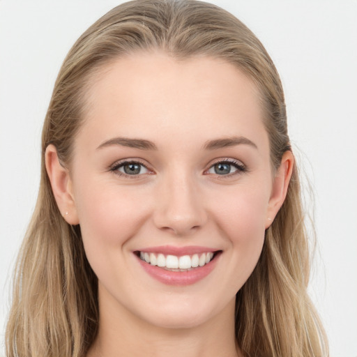 Joyful white young-adult female with long  brown hair and blue eyes