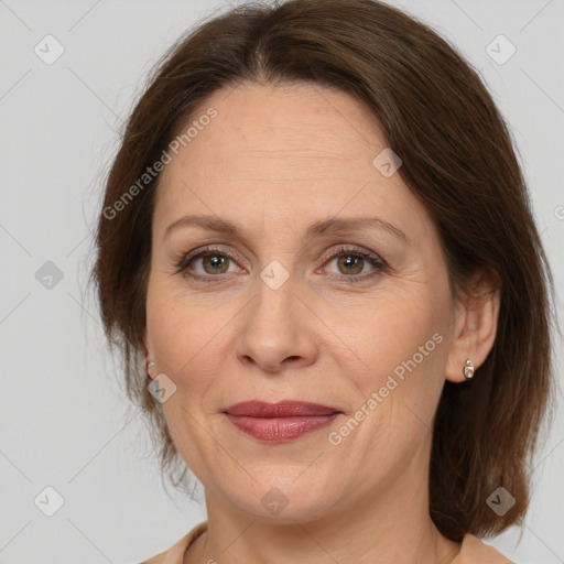 Joyful white adult female with medium  brown hair and brown eyes