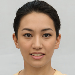 Joyful asian young-adult female with short  brown hair and brown eyes