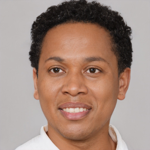 Joyful latino adult male with short  brown hair and brown eyes