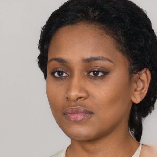 Neutral black young-adult female with medium  black hair and brown eyes