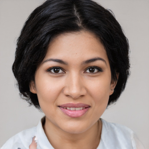 Joyful latino young-adult female with medium  brown hair and brown eyes