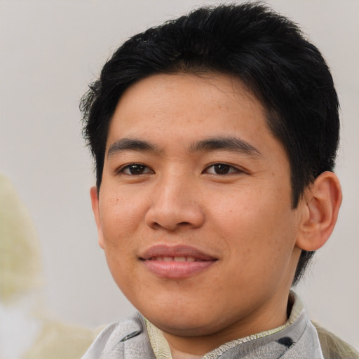 Joyful asian young-adult male with short  brown hair and brown eyes