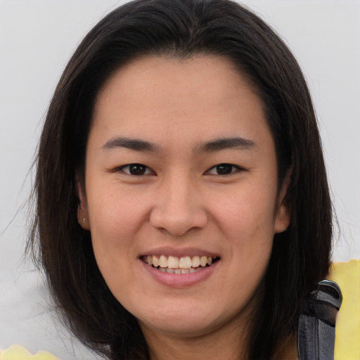 Joyful asian young-adult female with long  brown hair and brown eyes