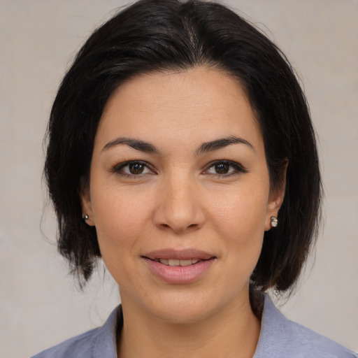 Joyful asian young-adult female with medium  brown hair and brown eyes