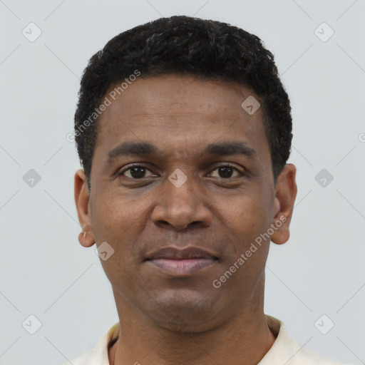 Joyful black young-adult male with short  brown hair and brown eyes