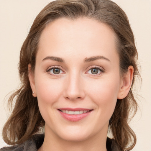 Joyful white young-adult female with long  brown hair and blue eyes