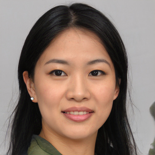 Joyful asian young-adult female with long  black hair and brown eyes