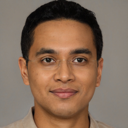 Joyful latino young-adult male with short  black hair and brown eyes