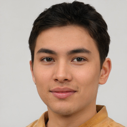 Joyful asian young-adult male with short  brown hair and brown eyes