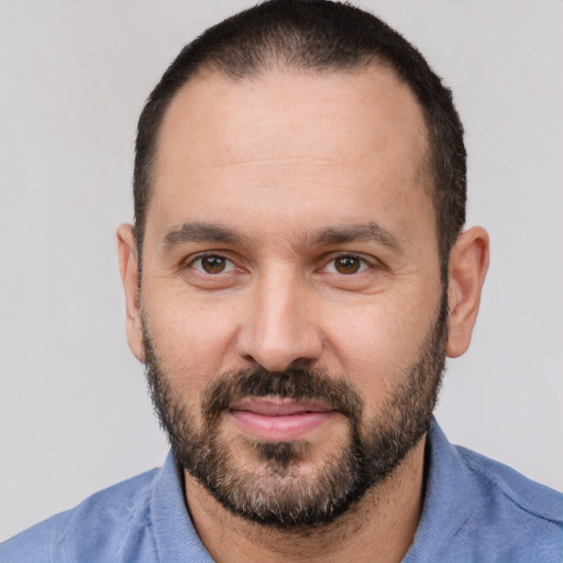 Joyful white adult male with short  black hair and brown eyes