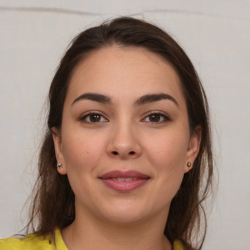 Joyful white young-adult female with medium  brown hair and brown eyes