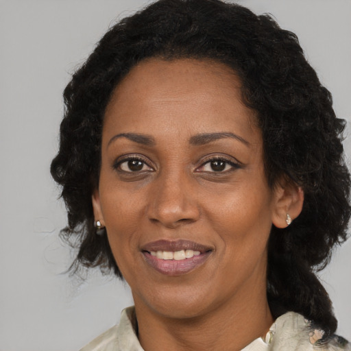 Joyful black adult female with medium  black hair and brown eyes