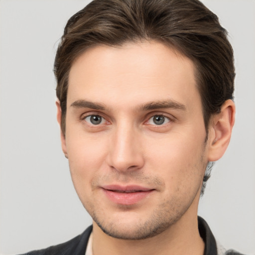 Joyful white young-adult male with short  brown hair and brown eyes