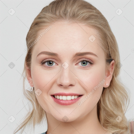 Joyful white young-adult female with long  brown hair and blue eyes