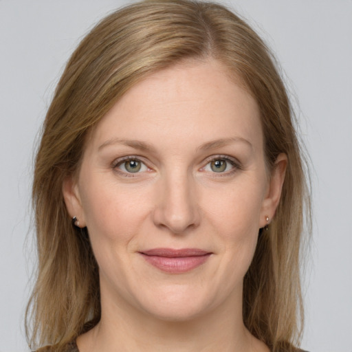 Joyful white young-adult female with long  brown hair and grey eyes