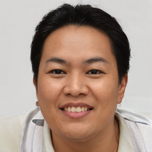 Joyful asian young-adult female with short  brown hair and brown eyes