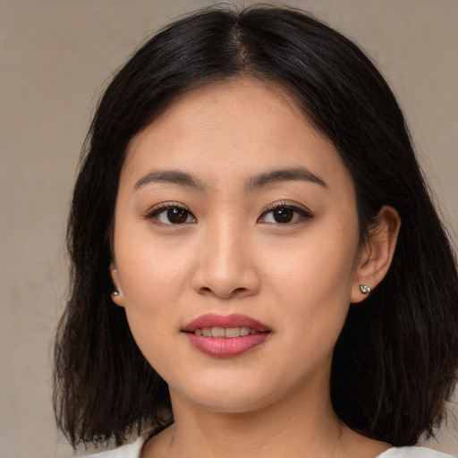 Joyful asian young-adult female with medium  brown hair and brown eyes