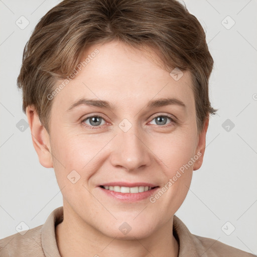 Joyful white young-adult female with short  brown hair and grey eyes