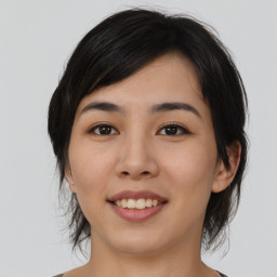 Joyful asian young-adult female with medium  black hair and brown eyes