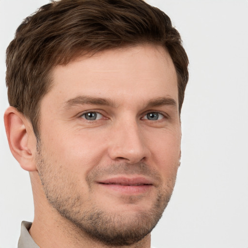 Joyful white young-adult male with short  brown hair and grey eyes