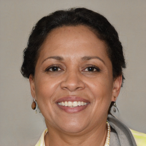 Joyful latino adult female with short  brown hair and brown eyes