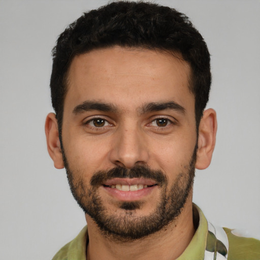 Joyful white young-adult male with short  black hair and brown eyes