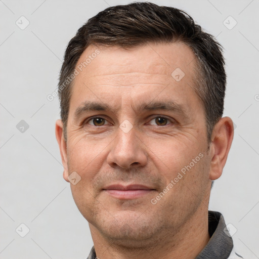 Joyful white adult male with short  brown hair and brown eyes